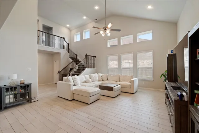 a living room with furniture chandelier and a flat screen tv