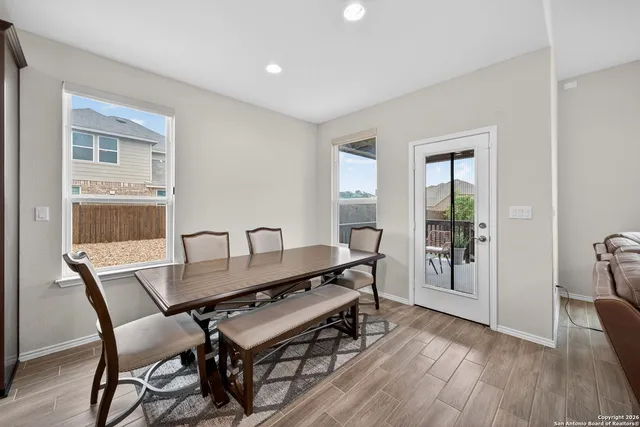 a dining room with furniture and wooden floor