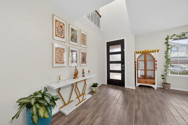 a view of an entryway with wooden floor and windows