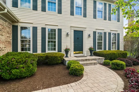a front view of a house with a garden