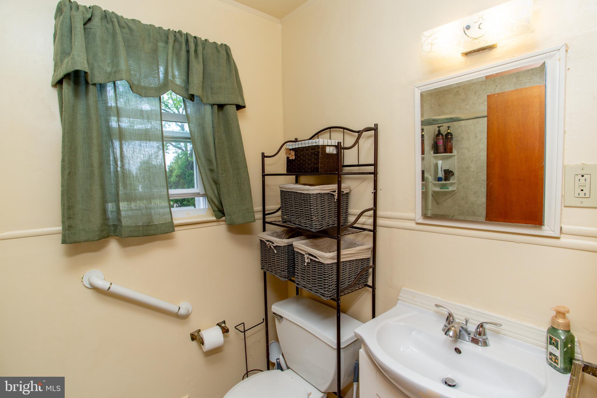 1264 Tulip Road Warminster, PA 18974 - Photo 18 of 21 a bathroom with a sink toilet and mirror