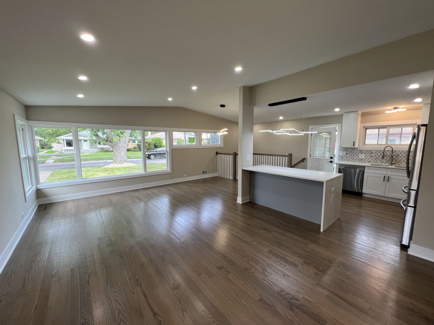 9446 Kolmar Avenue Skokie, IL 60076 - Photo 2 of 17 a open kitchen with stainless steel appliances granite countertop a large window a oven and white cabinets with wooden floors