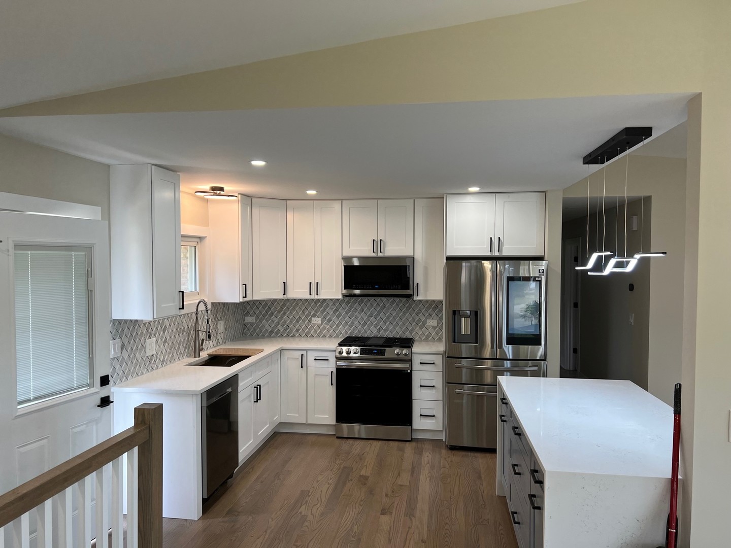 9446 Kolmar Avenue Skokie, IL 60076 - Photo 3 of 17 a kitchen with a refrigerator a sink and a stove