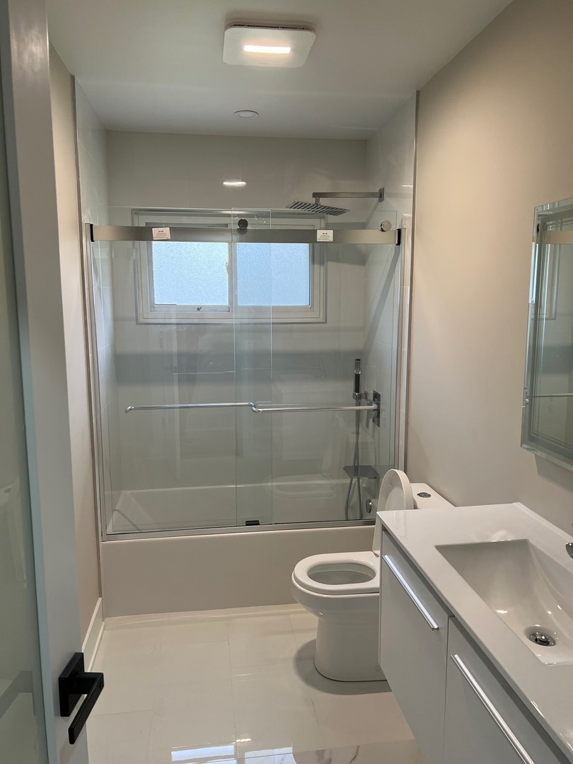 9446 Kolmar Avenue Skokie, IL 60076 - Photo 5 of 17 a bathroom with a sink a toilet and shower
