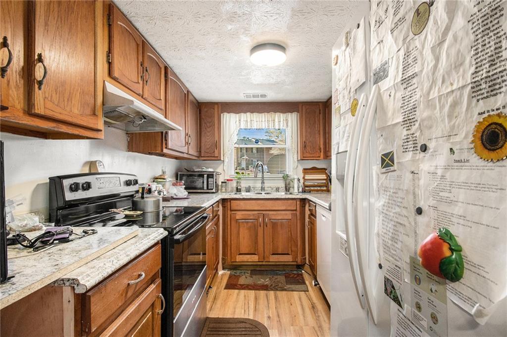4526 Golf Vista Circle Decatur, GA 30035 - Photo 11 of 31 a kitchen with a sink appliances cabinets and a counter top space