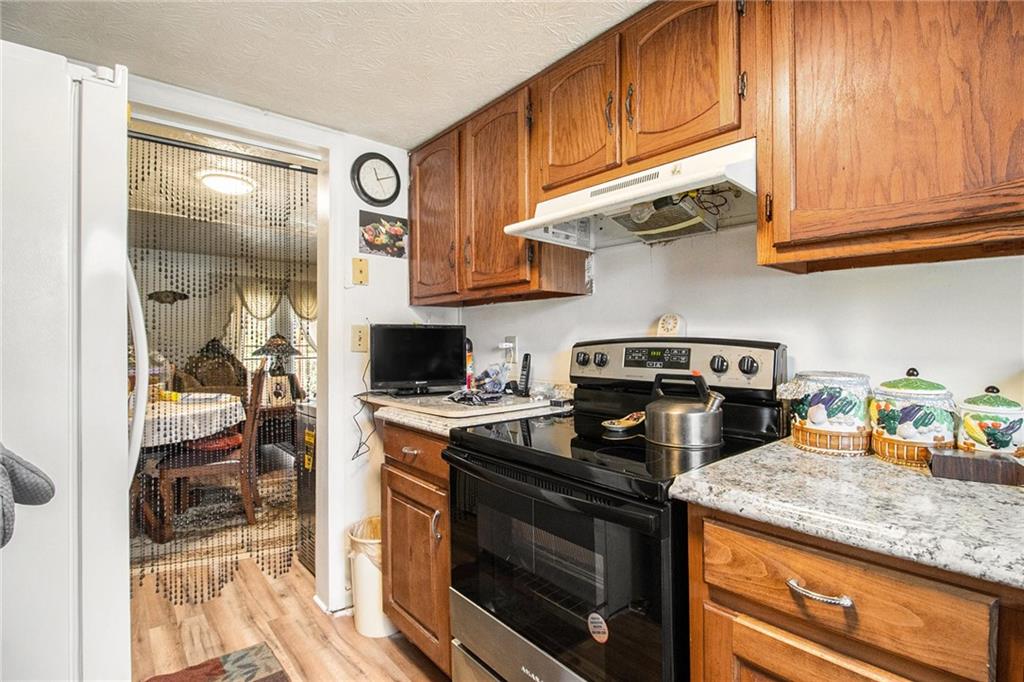 4526 Golf Vista Circle Decatur, GA 30035 - Photo 14 of 31 a kitchen with stainless steel appliances granite countertop a stove and a sink