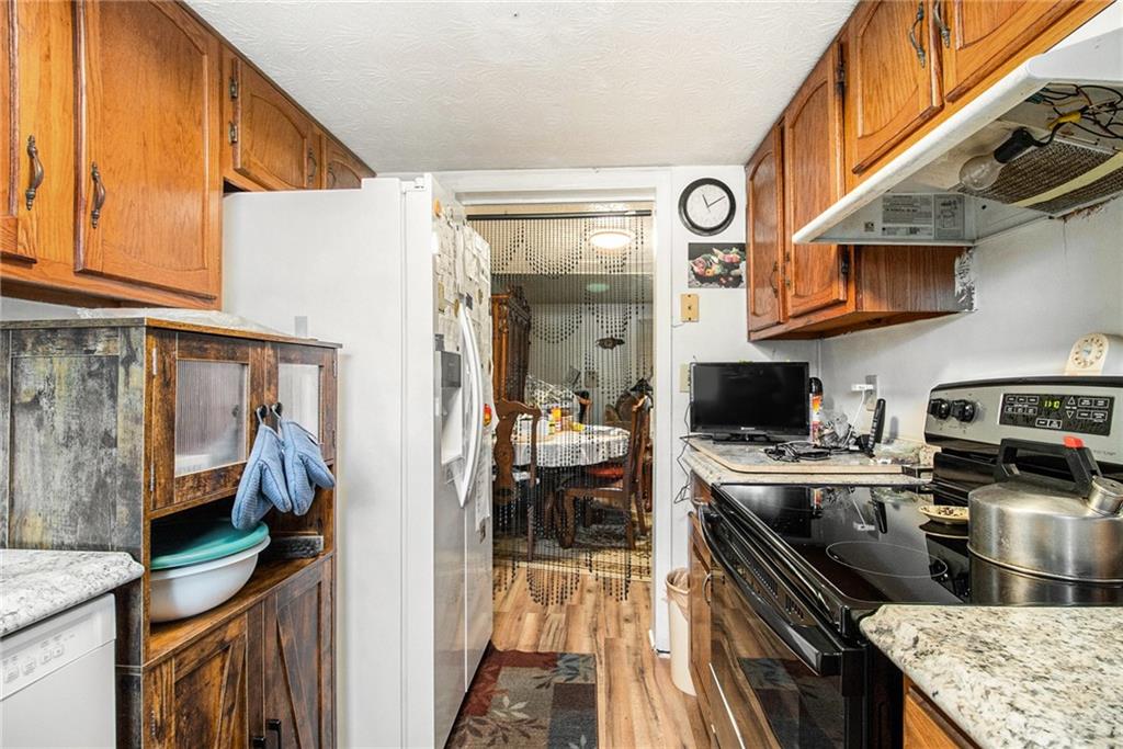 4526 Golf Vista Circle Decatur, GA 30035 - Photo 15 of 31 a kitchen with stainless steel appliances granite countertop a stove and a sink