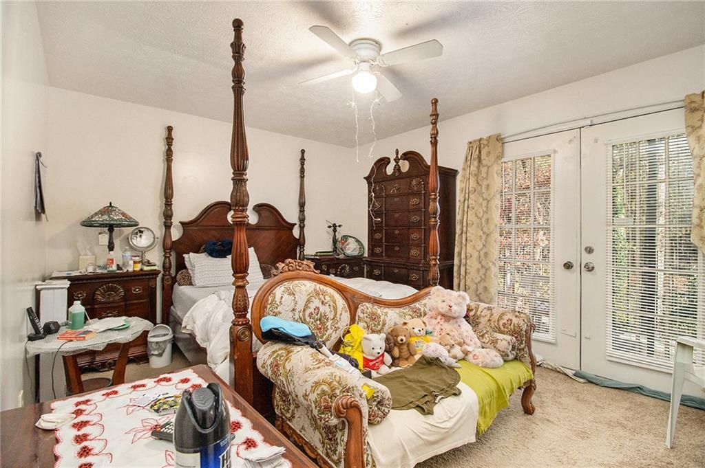 4526 Golf Vista Circle Decatur, GA 30035 - Photo 19 of 31 a bedroom with bed and glass door