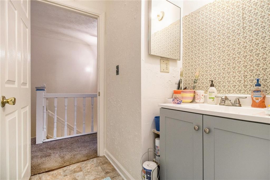 4526 Golf Vista Circle Decatur, GA 30035 - Photo 21 of 31 a bathroom with a sink and a mirror