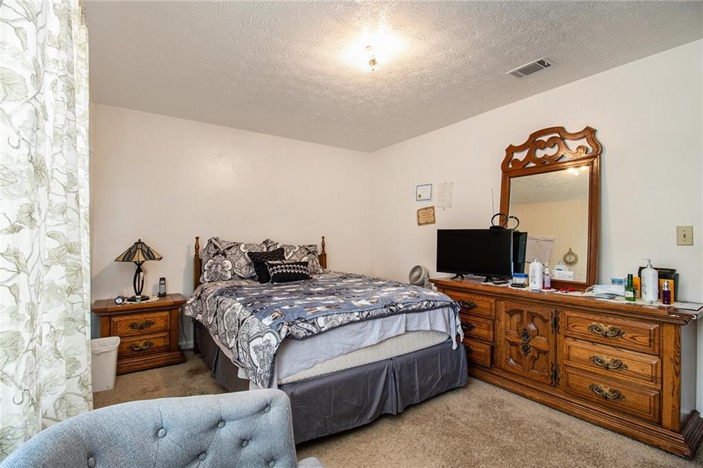 4526 Golf Vista Circle Decatur, GA 30035 - Photo 23 of 31 a bedroom with a bed and a flat screen tv
