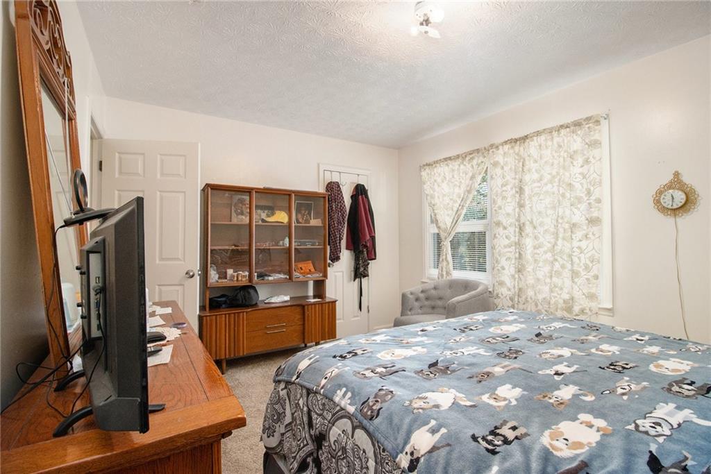 4526 Golf Vista Circle Decatur, GA 30035 - Photo 24 of 31 a bedroom with a bed and large windows