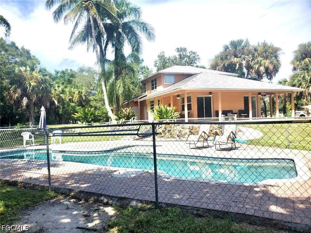 740 19th Street Southwest Naples, FL 34117 - Photo 20 of 35 a front view of a house with a yard
