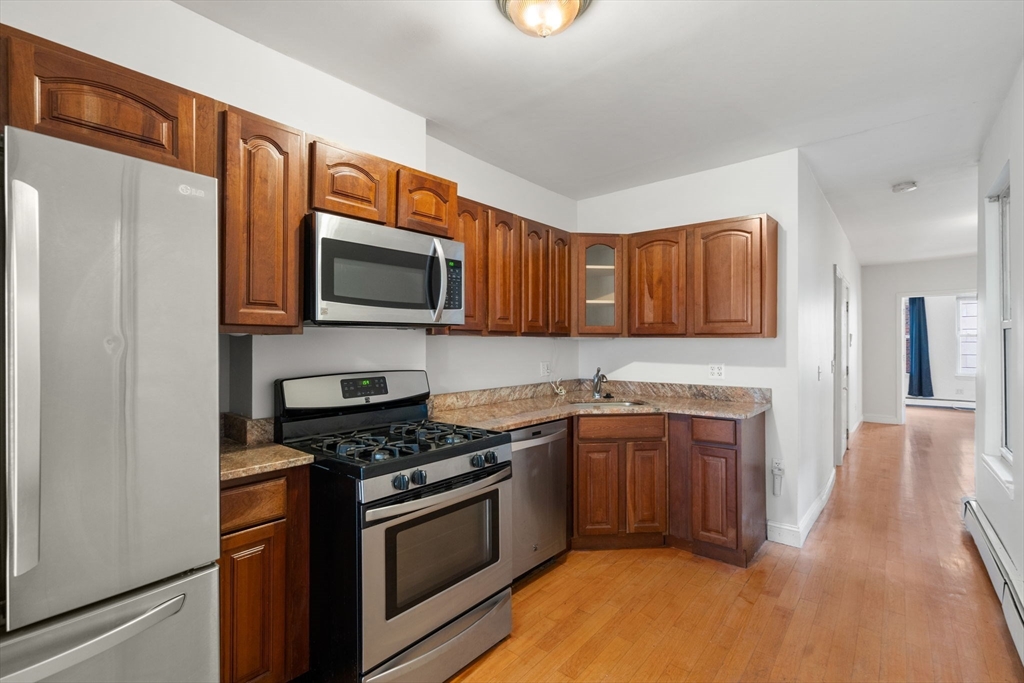 62 North Margin Street, Unit 2 Boston, MA 02113 - Photo 3 of 10 a kitchen with stainless steel appliances granite countertop a stove top oven a sink and dishwasher