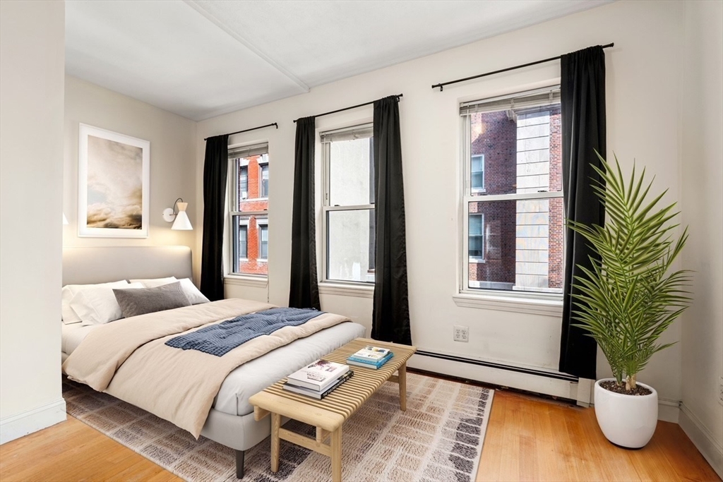 62 North Margin Street, Unit 2 Boston, MA 02113 - Photo 7 of 10 a bedroom with a bed and large window with outer view