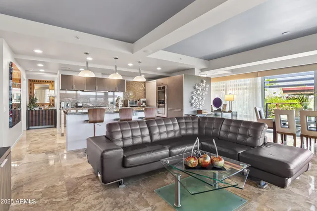 a living room with furniture and kitchen view
