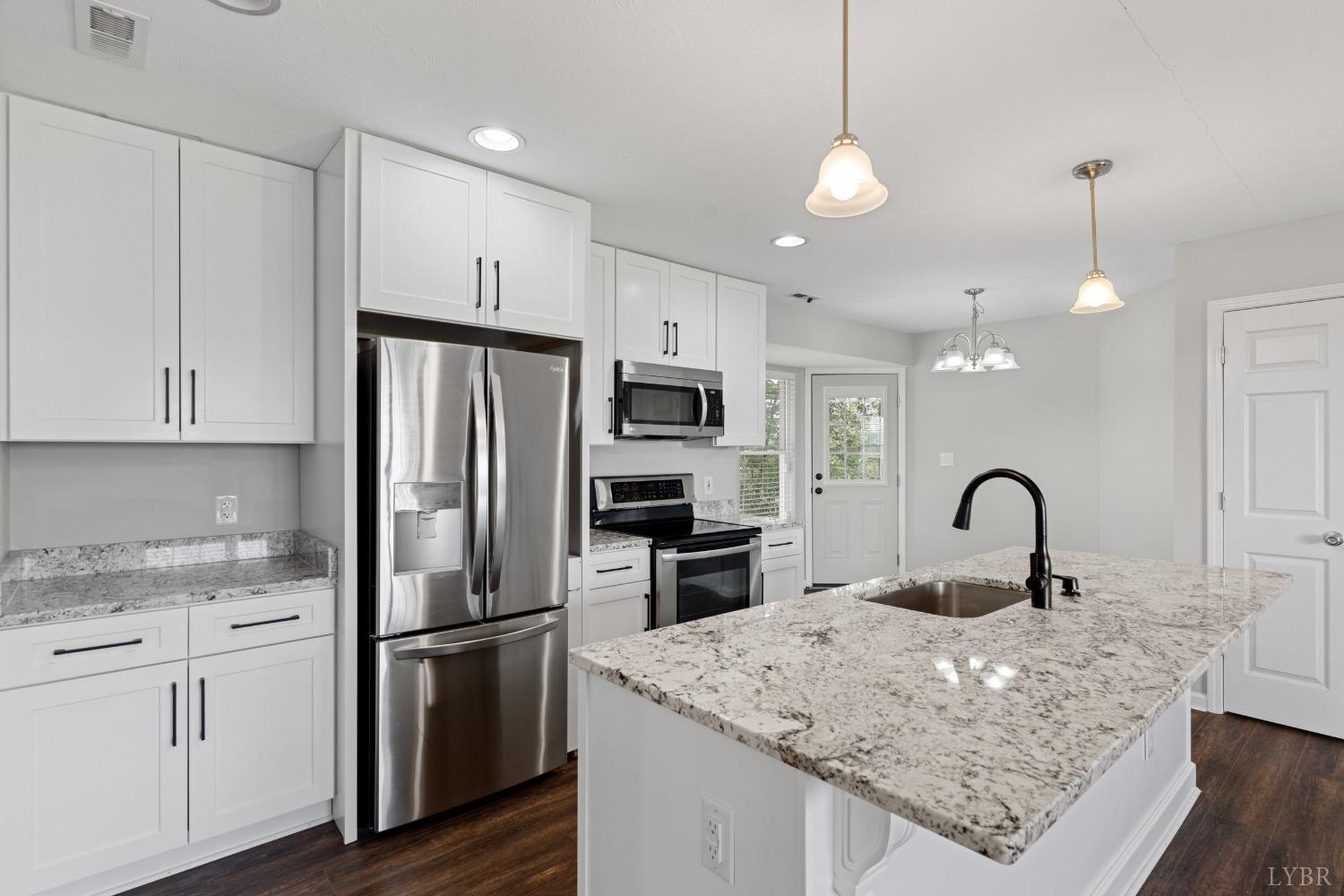 4657 Stage Road Concord, VA 24538 - Photo 14 of 29 a kitchen with kitchen island a sink stainless steel appliances and refrigerator