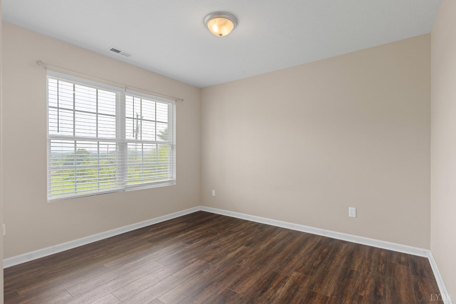 4657 Stage Road Concord, VA 24538 - Photo 23 of 29 an empty room with wooden floor and windows