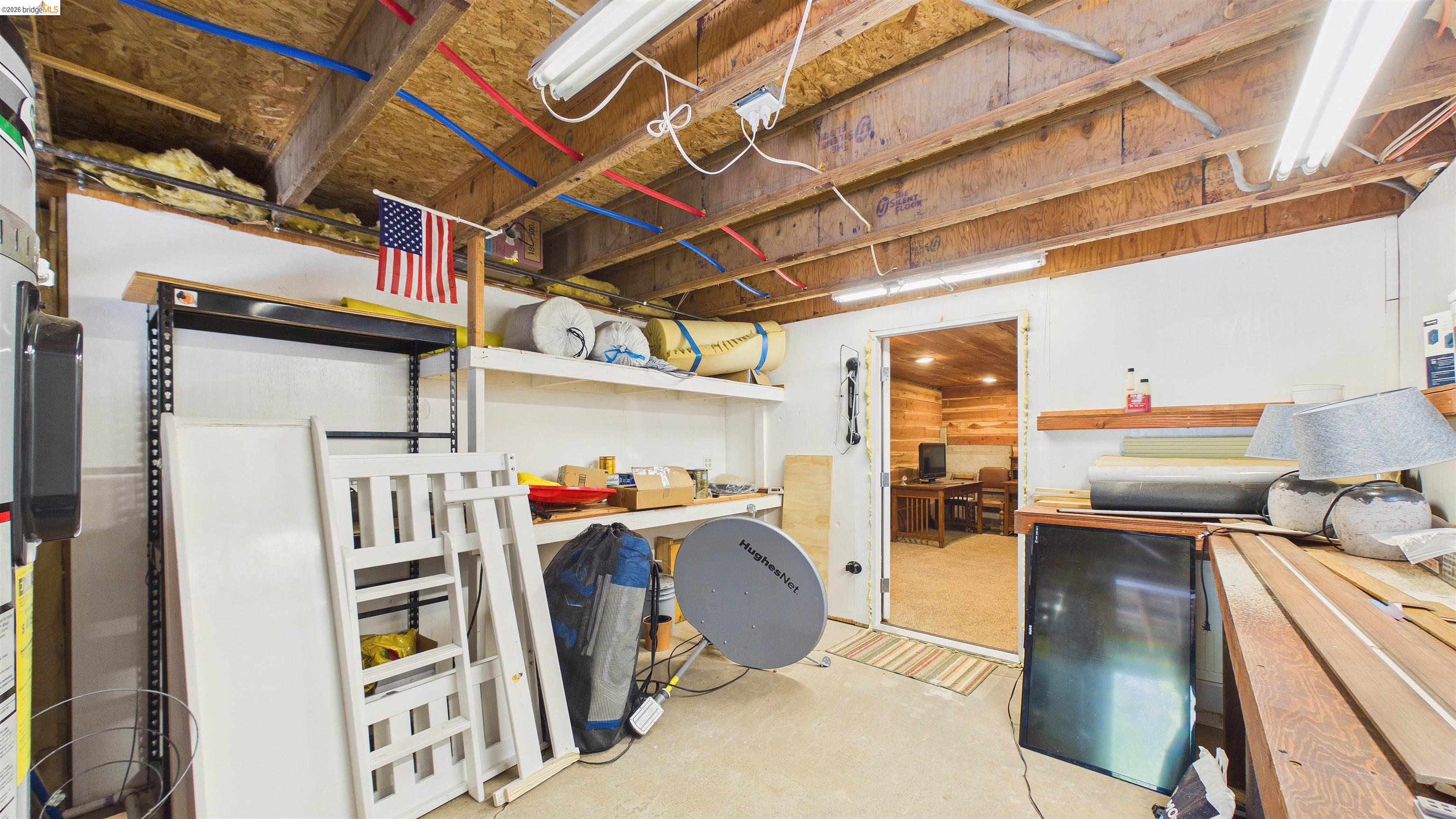 26570 Crystal Road Long Barn, CA 95335 - Photo 28 of 39 Unfinished basement space featuring exposed wood joists, fluorescent lighting, and concrete flooring