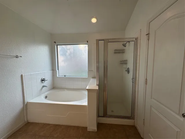 a bathroom with a bathtub and shower