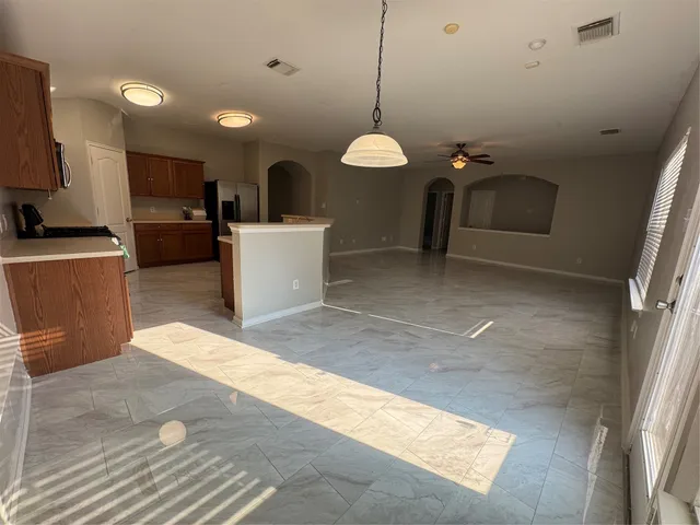 a kitchen with a sink a stove a counter space and cabinets