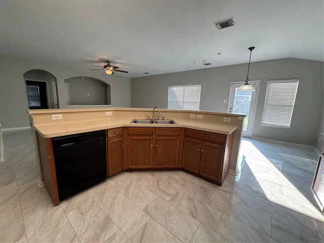 a kitchen with stainless steel appliances granite countertop a stove a sink and a refrigerator