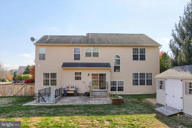 a front view of house with yard and swimming pool