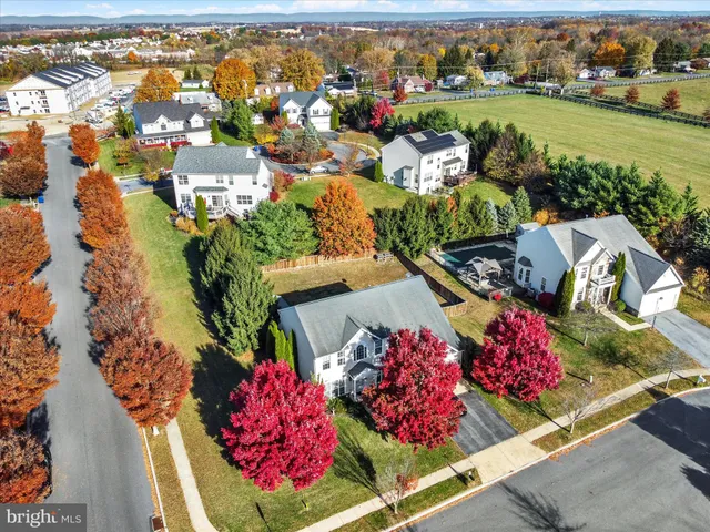 an aerial view of a house with a garden and lake view