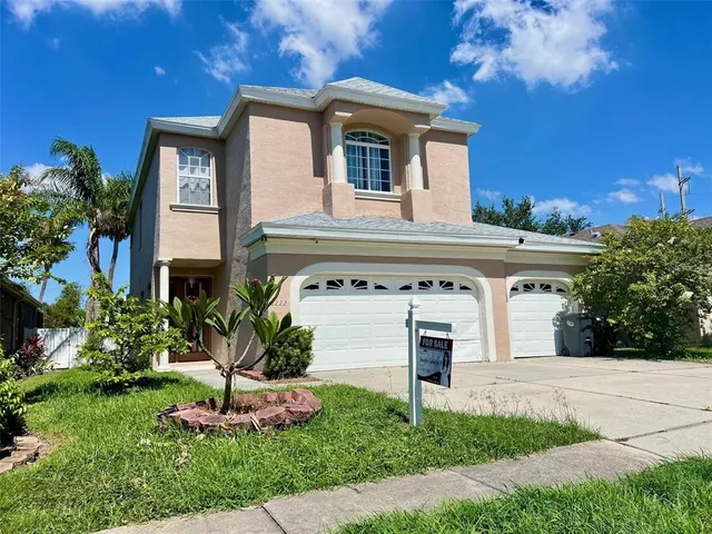 a front view of a house with a yard and garage