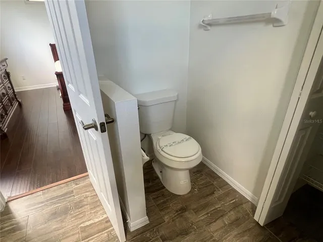 a white toilet sitting next to a sink