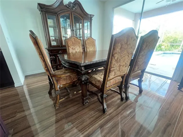 a view of a dining room with furniture window and wooden floor