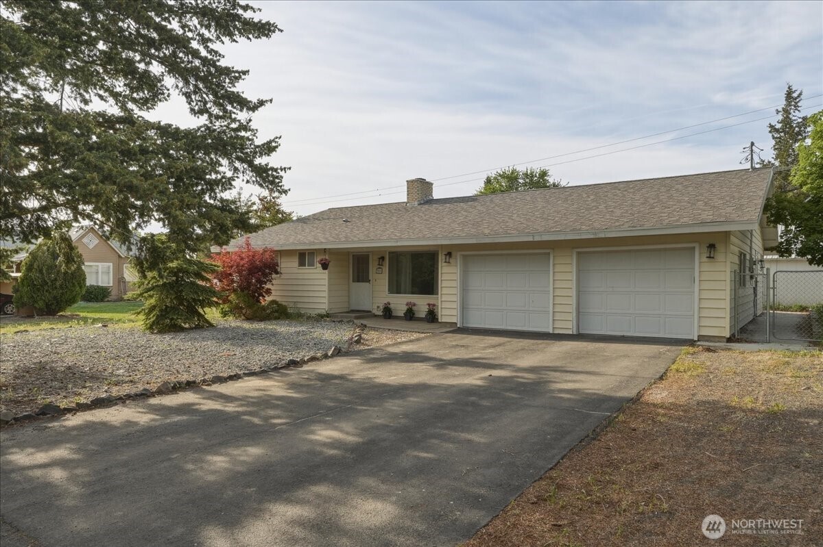 309 West Walnut Street Waterville, WA 98858 - Photo 1 of 28 a front view of a house with a garden and yard