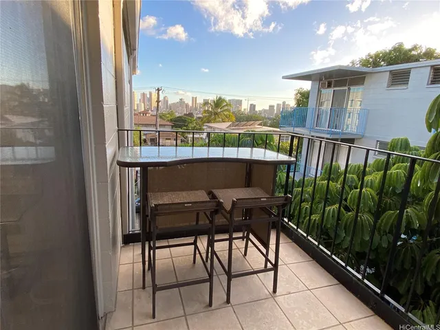 a balcony with table and chairs
