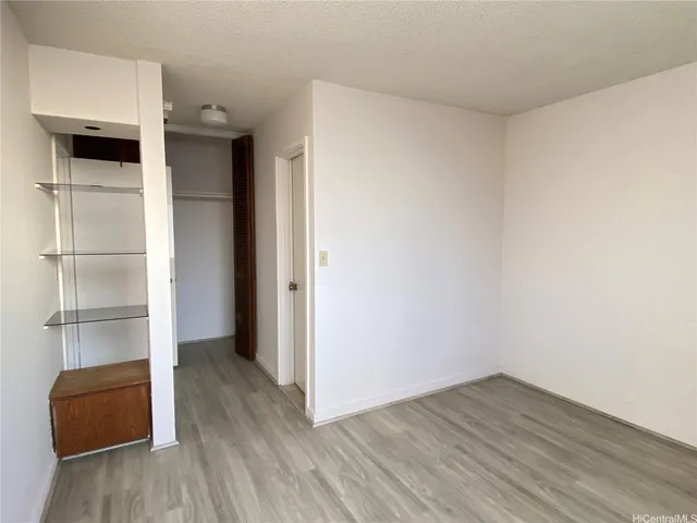 a view of walk in closet with wooden floor