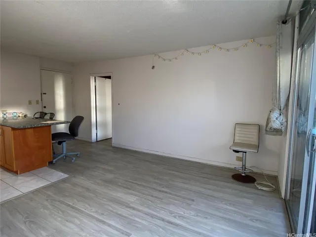 a view of workspace with wooden floor cabinet and windows