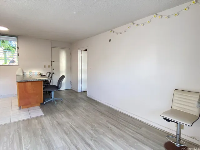 a workspace with wooden floor and a chair