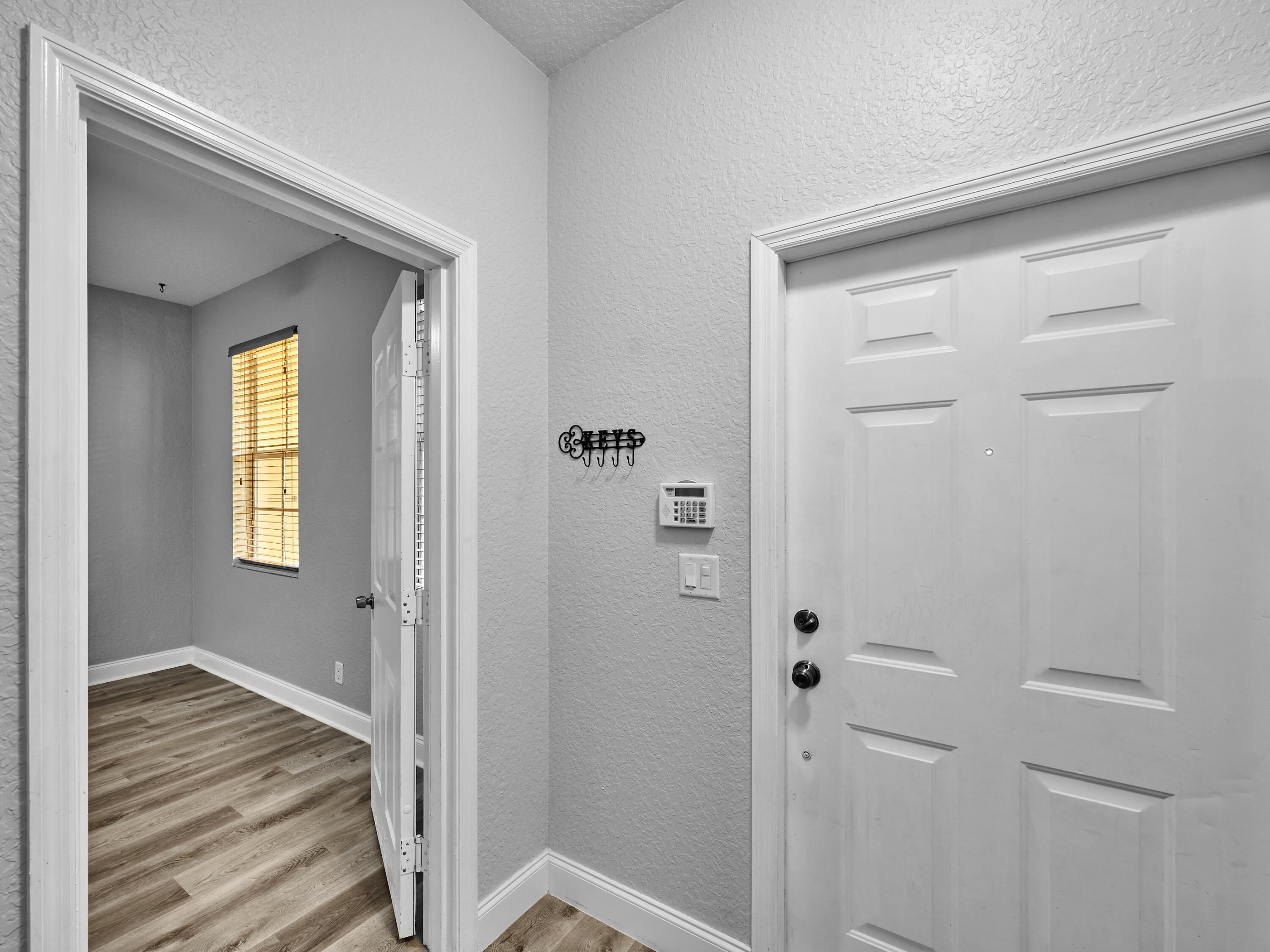 105 East Pigeon Plum Drive, Unit 103 Jupiter, FL 33458 - Photo 6 of 38 a view of a hallway with wooden floor and closet area