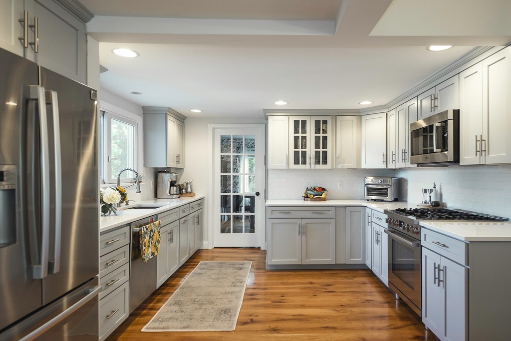 50 Jeffrey's Neck Road Ipswich, MA 01938 - Photo 17 of 41 a kitchen with stainless steel appliances granite countertop a stove top oven a sink dishwasher a refrigerator and a refrigerator
