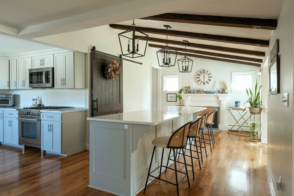 50 Jeffrey's Neck Road Ipswich, MA 01938 - Photo 20 of 41 a kitchen with stainless steel appliances granite countertop a refrigerator and microwave