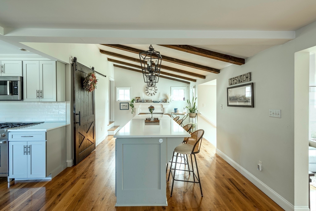 50 Jeffrey's Neck Road Ipswich, MA 01938 - Photo 21 of 41 a kitchen with kitchen island a stove and a refrigerator