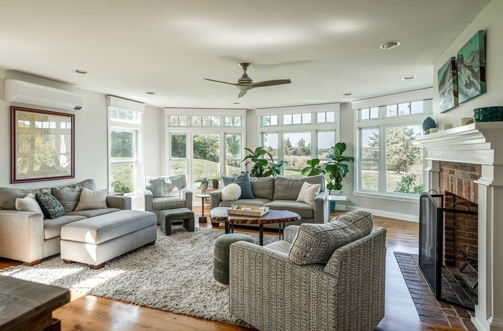 50 Jeffrey's Neck Road Ipswich, MA 01938 - Photo 24 of 41 a living room with furniture a fireplace and a large window