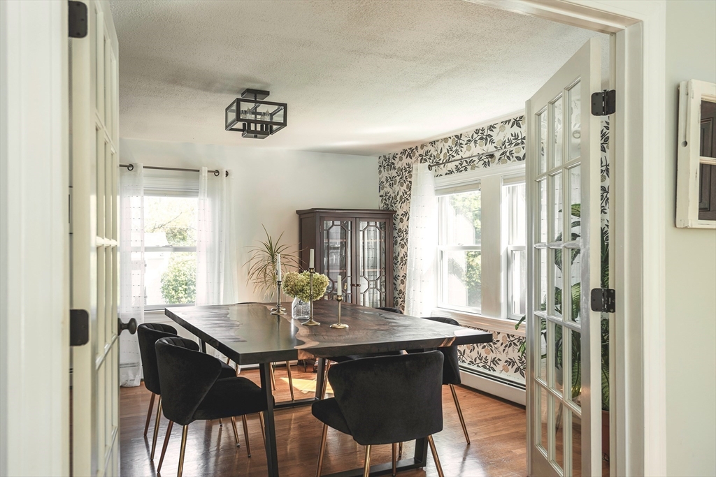 50 Jeffrey's Neck Road Ipswich, MA 01938 - Photo 28 of 41 a view of a dining room with furniture wooden floor and a chandelier