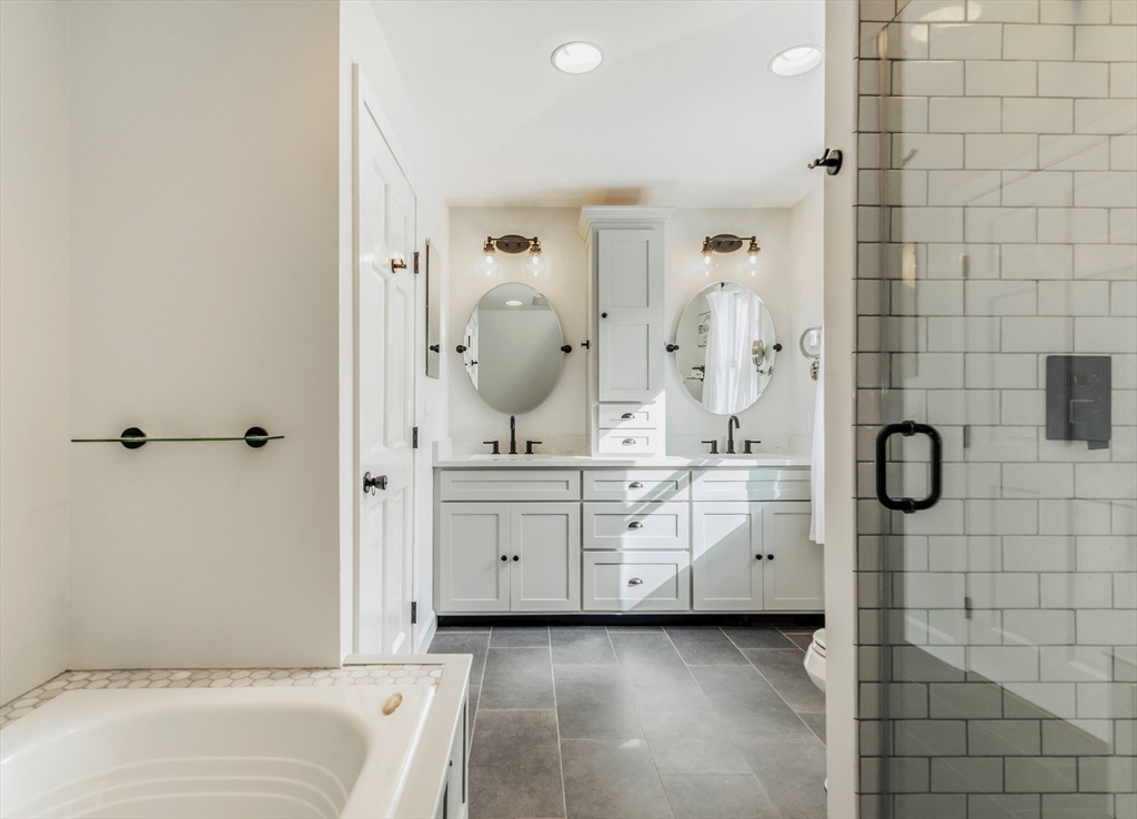 50 Jeffrey's Neck Road Ipswich, MA 01938 - Photo 29 of 41 a bathroom with a tub sink and mirror