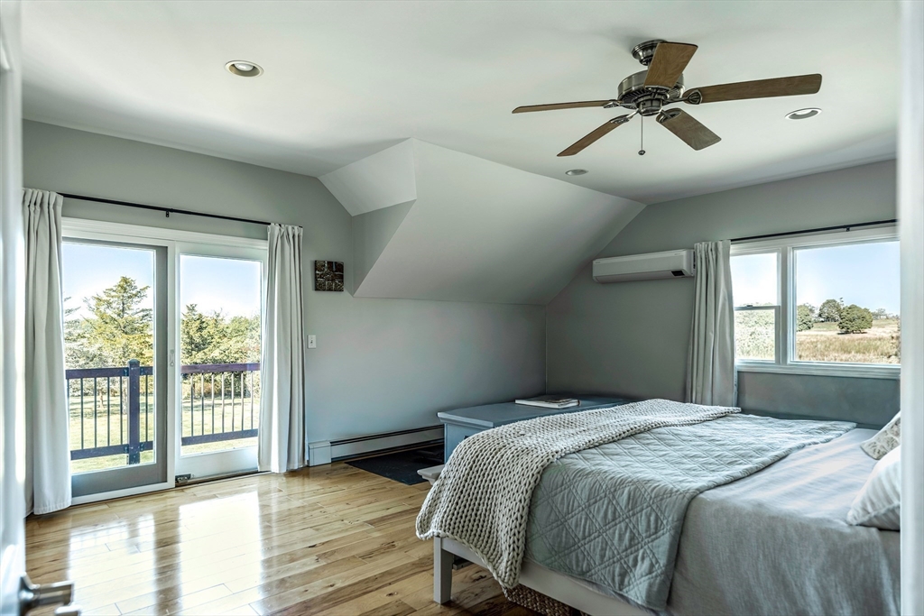 50 Jeffrey's Neck Road Ipswich, MA 01938 - Photo 31 of 41 a bedroom with a large bed and a large window