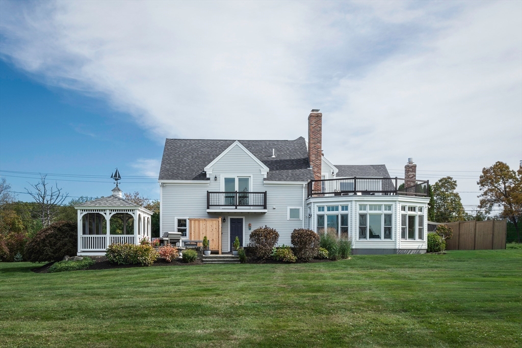 50 Jeffrey's Neck Road Ipswich, MA 01938 - Photo 4 of 41 a front view of a house with a garden