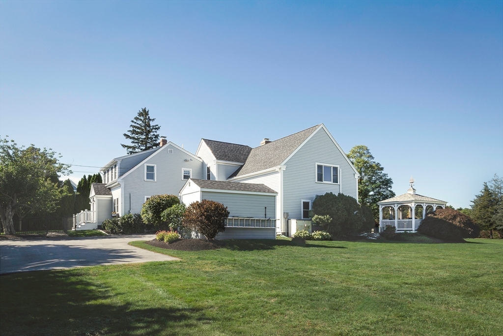 50 Jeffrey's Neck Road Ipswich, MA 01938 - Photo 6 of 41 a front view of a house with a garden