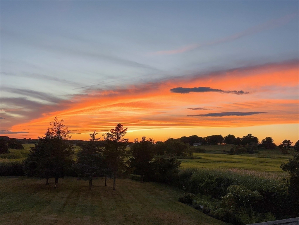 50 Jeffrey's Neck Road Ipswich, MA 01938 - Photo 10 of 41 a view of a lake in middle of sunset