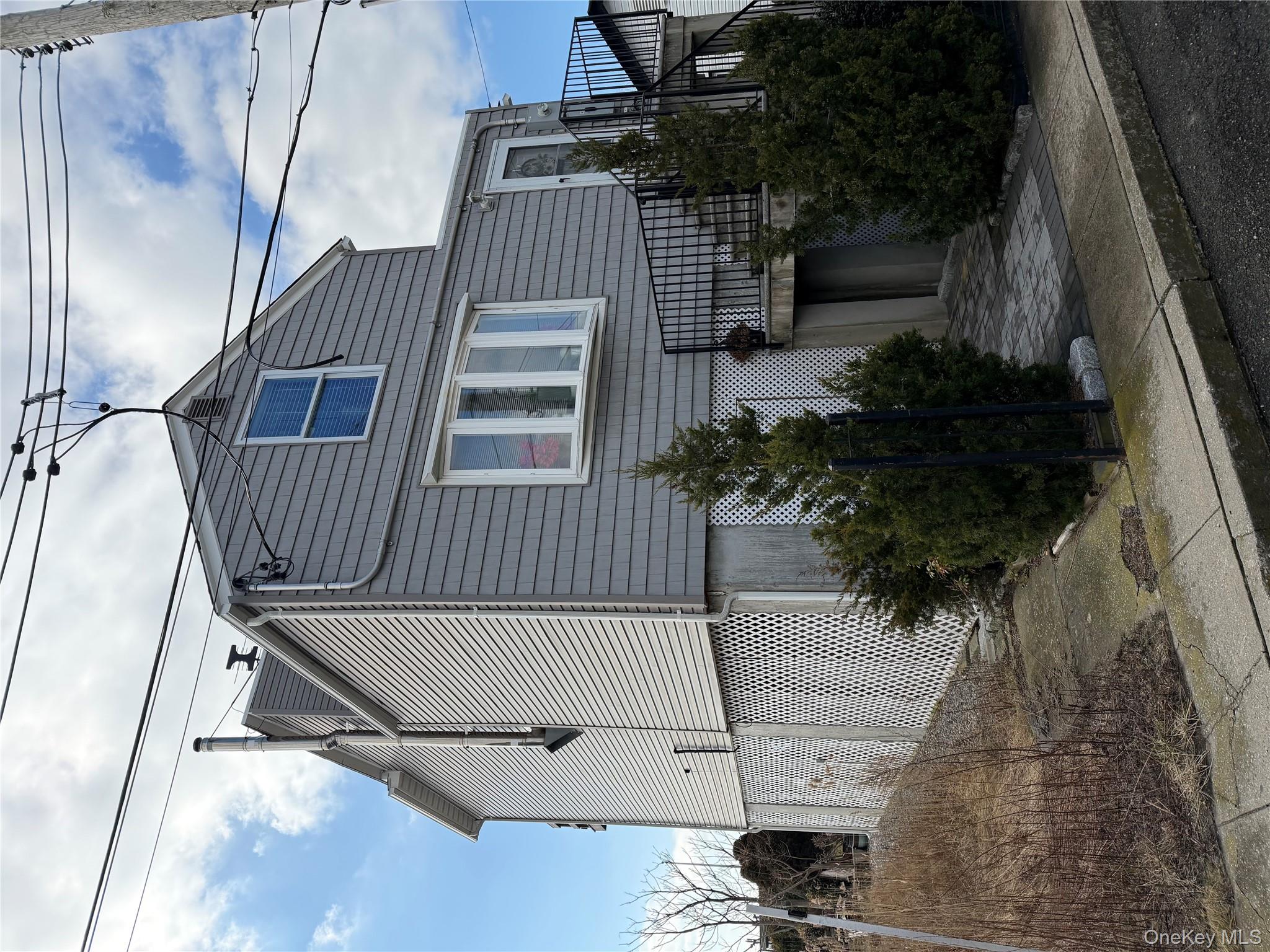 308 East 8th Road Queens, NY 11693 - Photo 4 of 7 a view of a house with a yard