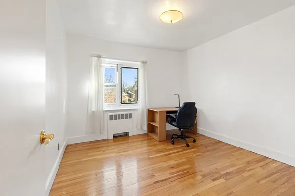 a view of a workspace with wooden floor