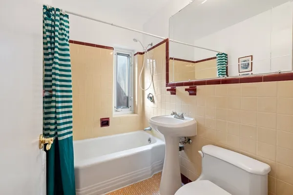a utility room with dryer washer and a view of kitchen