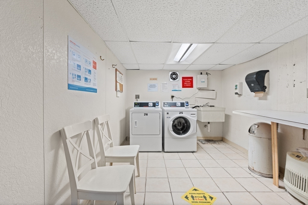 130 Boylston Street, Unit 3 Newton, MA 02467 - Photo 15 of 24 a utility room with dryer washer and a view of kitchen